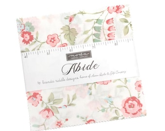 May include: A stack of fabric squares with a floral pattern in pink, red, and green on a white background. The squares are held together by a white label that reads "Abide" and "Moda Fabrics & Supplies". The squares are approximately 8 inches in length.