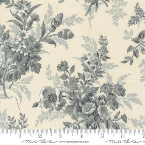 May include: A cream-colored fabric featuring a repeating floral pattern in shades of slate gray. The design includes clusters of various flowers and leafy sprigs. A white ruler is visible at the bottom, showing measurements in inches.