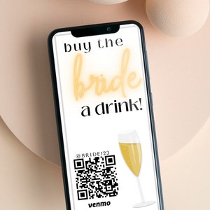 Op de afbeelding: Een smartphone-scherm met een afbeelding waarop staat "buy the bride a drink!" met een QR-code en de tekst "@BRIDE123 venmo".