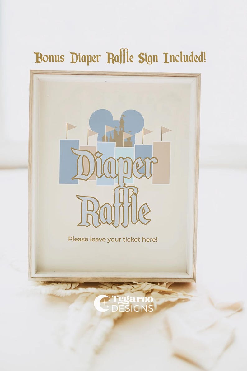 May include: Framed sign with the words "Diaper Raffle" in a decorative font, featuring a castle and Mickey Mouse ears design in blue and tan. The text "Please leave your ticket here!" is below. The sign is in a light wood frame.