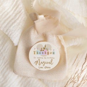 May include: A round, beige thank you tag with a castle illustration and the text "Thank you for making my birthday magical Love Olivia".