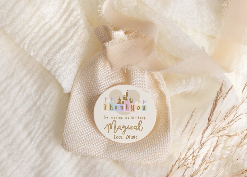 May include: A round, beige thank you tag with a castle illustration and the text "Thank you for making my birthday magical Love Olivia".