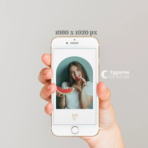 May include: A woman smiles while holding a slice of watermelon in front of a phone screen. The phone screen shows a photo of the woman with a watermelon, a heart, and the text "Tegaroo Designs".