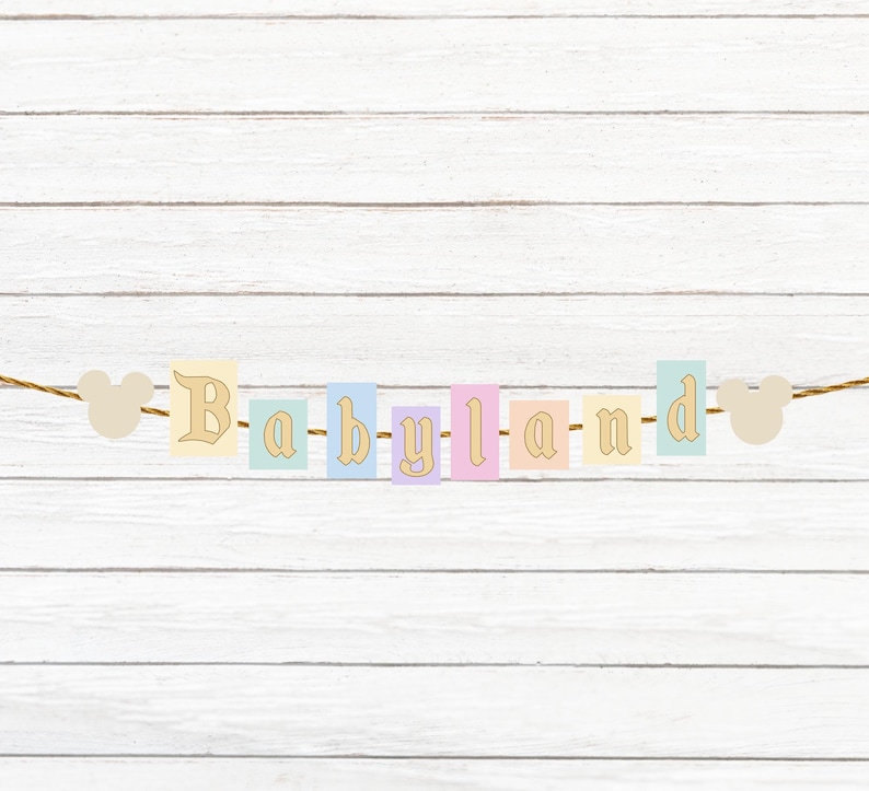 May include: A pastel colored banner with the word "Babyland" spelled out on it. The banner is strung with a brown twine and has two white mouse ears on either end.