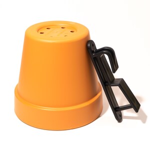 May include: Orange plastic plant pot with drainage holes and a black plastic hook.