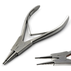 May include: A pair of stainless steel jewelry pliers with a spring-loaded mechanism. The pliers have two sets of jaws, one set with a pointed tip and the other set with a flat tip. The pliers are used for bending and shaping jewelry.