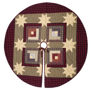 May include: A red and green plaid quilted Christmas tree skirt with a star and log cabin design. The skirt has a 48-inch diameter and a hole in the center for the tree stand.