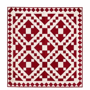 May include: A square quilt featuring a geometric pattern of deep red and off-white fabric blocks. The design consists of large diamond shapes formed by smaller squares, with a continuous border of alternating red and white diamond-shaped pieces.