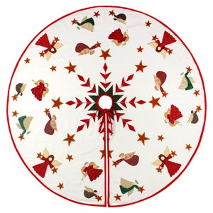 May include: White Christmas tree skirt with a red snowflake design and embroidered angels holding stars. The skirt has a red border.