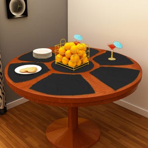 May include: A round wooden table with a dark brown finish, featuring black placemats. A gold wire basket filled with oranges sits in the center. Small plates and a cocktail with an umbrella are also on the table.