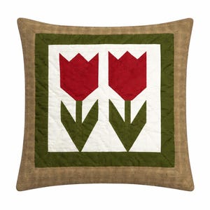May include: Square cushion with a quilted design featuring two red tulip flowers on a white background, framed by a green border and a burlap-textured outer edge. The cushion is square.