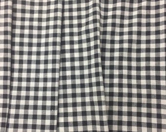 May include: Black and white gingham fabric with a checkered pattern. The fabric is folded in thirds, showing the pattern from different angles.