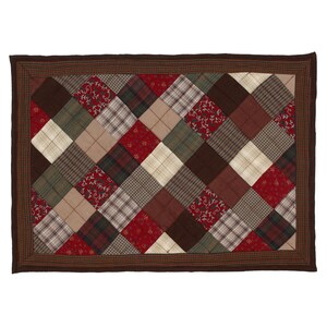 May include: A rectangular patchwork quilt featuring a diamond pattern. The quilt showcases a variety of fabrics in shades of brown, red, green, and cream. The border is a darker brown with a plaid design.