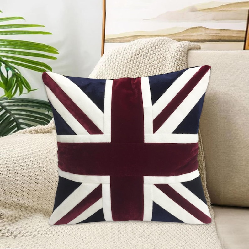 May include: A decorative throw pillow with a red, white, and blue Union Jack design. The pillow is made of a soft, plush fabric and has a square shape.