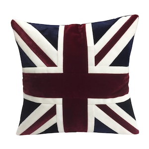 May include: A square throw pillow with a red, white, and blue Union Jack design. The pillow is made of a soft, plush fabric.