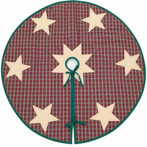 May include: A circular quilted tree skirt featuring a red and green plaid pattern with cream-colored star appliqués. The center has a star-shaped cutout with a green fabric tie closure, and the entire edge is finished with green binding.