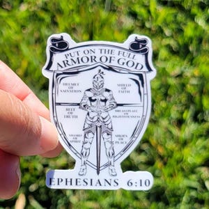 May include: A white sticker with a black and white illustration of a knight in armor. The text "Put on the full armor of God" is at the top of the sticker. The text "Ephesians 6:10" is at the bottom of the sticker.