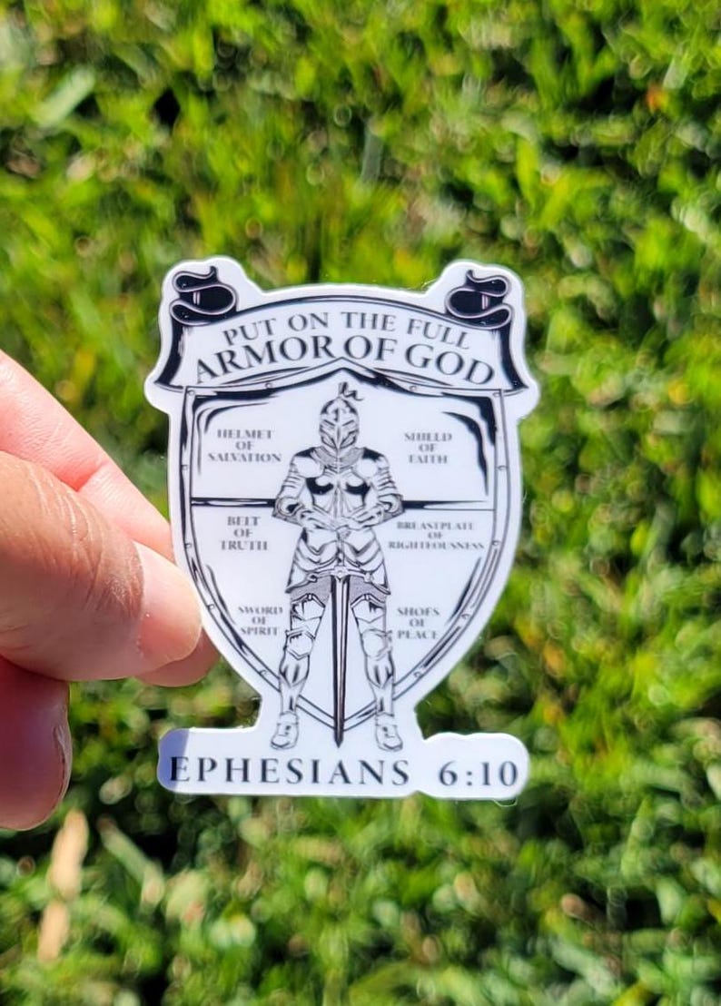 May include: A white sticker with a black and white illustration of a knight in armor. The text "Put on the full armor of God" is at the top of the sticker. The text "Ephesians 6:10" is at the bottom of the sticker.