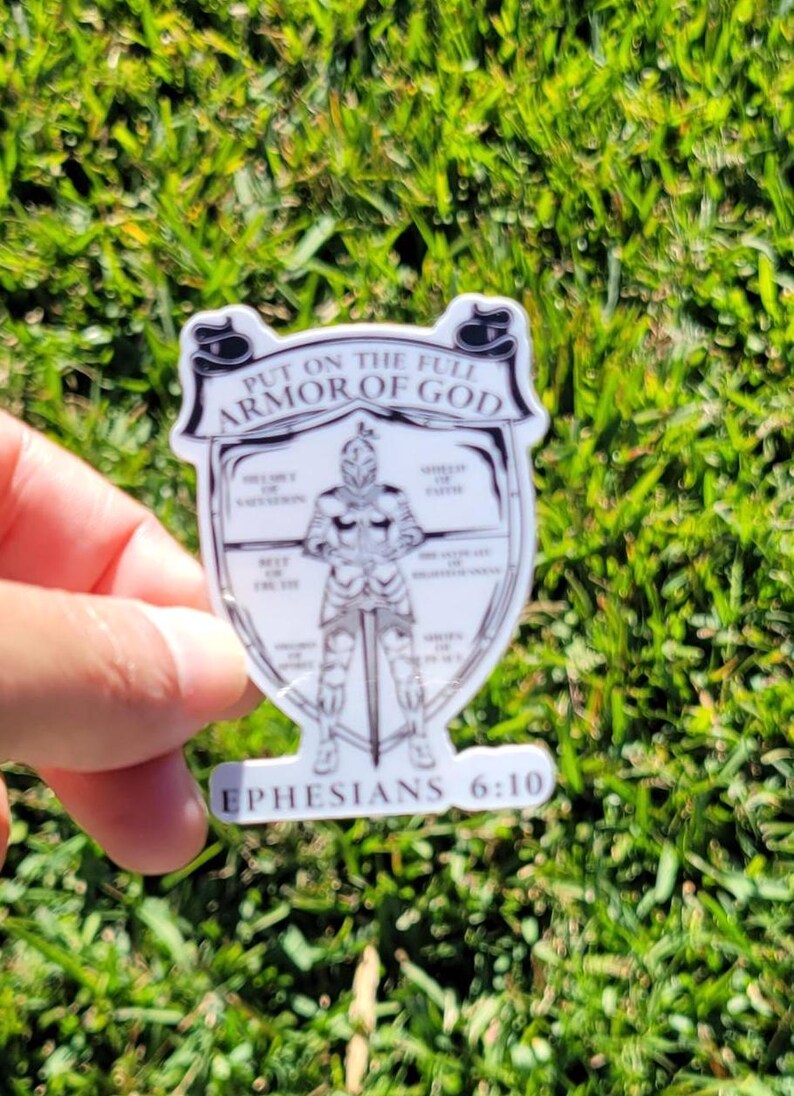 May include: A white sticker with a black and white illustration of a knight in armor. The text "Put on the full armor of God" is at the top of the sticker. The text "Ephesians 6:10" is at the bottom of the sticker.