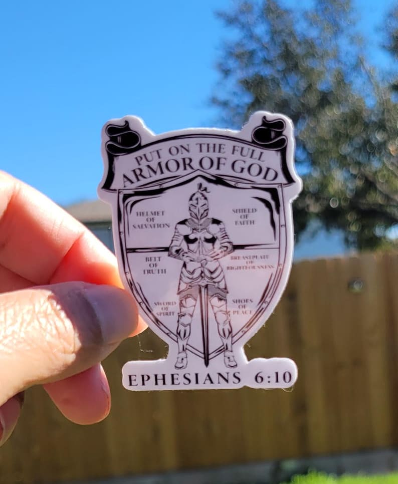 May include: A white sticker with a black and white illustration of a knight wearing armor. The text "PUT ON THE FULL ARMOR OF GOD" is at the top of the sticker. The text "EPHESIANS 6:10" is at the bottom of the sticker.