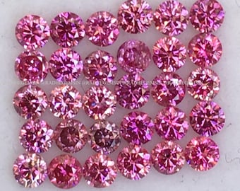 May include: A collection of 25 round, pink gemstones with a faceted cut. The gemstones are arranged in a rectangular shape.