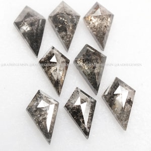 May include: A collection of eight black diamond kite-shaped gemstones. The diamonds are faceted and have a dark, smoky appearance.