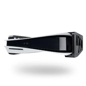 May include: A white and black gaming console with a black stand. The console has a sleek, curved design with a black center section and white side panels. The stand is black and has a grid-like pattern.