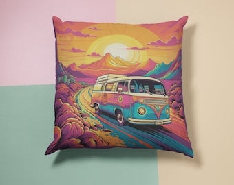 May include: A colorful pillow featuring a vintage van driving on a winding road through a desert landscape with a sunset in the background.