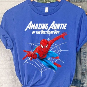 May include: Blue t-shirt with the text "Amazing Auntie of the Birthday Boy" and a cartoon image of Spiderman in a web.