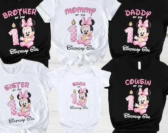 May include: Set of six t-shirts featuring a cartoon mouse with a pink bow and a pink and white polka dot candle. The shirts have the text "Brother of the 1 Birthday Girl", "Mommy of the 1 Birthday Girl", "Daddy of the 1 Birthday Girl", "Sister of the 1 Birthday Girl", "Sara of the 1 Birthday Girl", and "Cousin of the 1 Birthday Girl".
