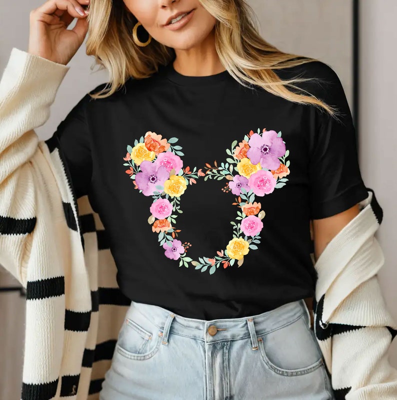 May include: Black t-shirt with a floral design in the shape of Mickey Mouse ears. The flowers are pink, yellow, orange, and purple.