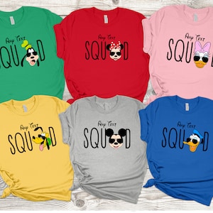 May include: Five t-shirts featuring various Disney characters. The shirts are in a range of colours, including green, red, pink, yellow, and blue. The characters depicted are Mickey Mouse, Minnie Mouse, Goofy, Donald Duck, and Pluto. The text on the shirts reads "Any Text SQUAD".