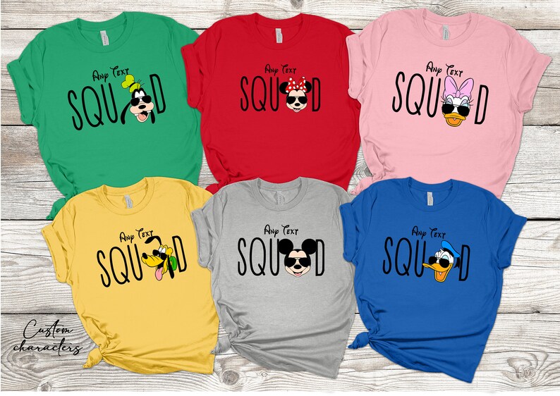 May include: Five t-shirts featuring various Disney characters. The shirts are in a range of colours, including green, red, pink, yellow, and blue. The characters depicted are Mickey Mouse, Minnie Mouse, Goofy, Donald Duck, and Pluto. The text on the shirts reads "Any Text SQUAD".