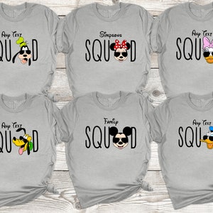 May include: Six grey t-shirts featuring various Disney characters sporting sunglasses and the word "SQUAD" printed on each. The characters include Mickey Mouse, Minnie Mouse, Goofy, Donald Duck, and Daisy Duck.