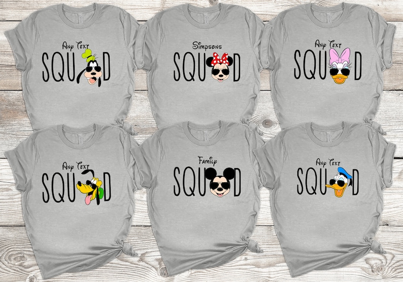 May include: Six grey t-shirts featuring various Disney characters sporting sunglasses and the word "SQUAD" printed on each. The characters include Mickey Mouse, Minnie Mouse, Goofy, Donald Duck, and Daisy Duck.
