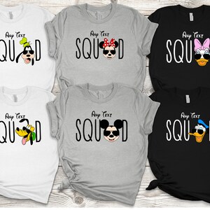 May include: Five white, grey and black t-shirts with the word "SQUAD" printed in black and a different Disney character wearing sunglasses on each shirt. The characters are Goofy, Minnie Mouse, Daisy Duck, Pluto and Donald Duck.