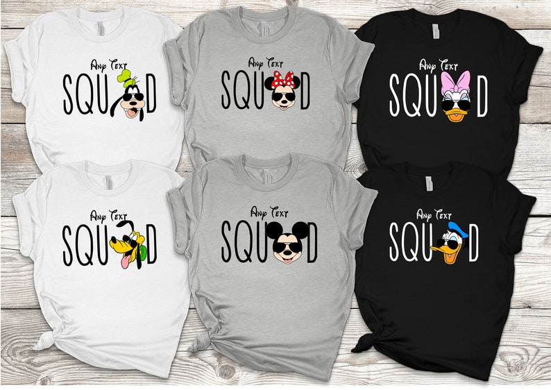 May include: Five white, grey and black t-shirts with the word "SQUAD" printed in black and a different Disney character wearing sunglasses on each shirt. The characters are Goofy, Minnie Mouse, Daisy Duck, Pluto and Donald Duck.