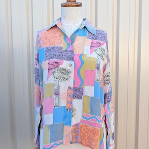 May include: A long-sleeved button-down shirt with a vibrant patchwork design. The shirt showcases a mix of pastel shades, such as pink, blue, orange, and purple, in geometric patterns. The shirt is presented on a mannequin.