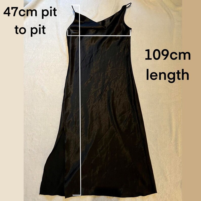 May include: Black satin slip dress with a 47 cm pit to pit measurement and a 109 cm length.