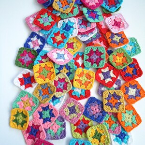 May include: A collection of colorful crocheted granny squares in various colors, including red, orange, yellow, green, blue, purple, pink, and white.