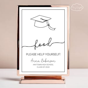 May include: A white sign with a black graduation cap and the text "food" in a cursive font. The sign also includes the text "PLEASE HELP YOURSELF!" and "Anna Robinson ANYTOWN HIGH SCHOOL CLASS OF 2024". The sign is on a gold stand.