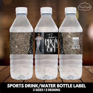 May include: Three clear plastic water bottles with black and gold labels. The labels feature a gold glitter background, a black border, and white text that reads "Talia's Prom Send Off". One label has a QR code and the text "Scan Me!" The labels are designed for sports drinks or water bottles.