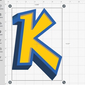 Puede incluir: Una letra K en 3D hecha de papel azul, amarillo y gris. La letra mide 5,688 pulgadas de ancho y 8,222 pulgadas de alto.