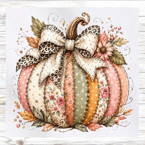 May include: A decorative pumpkin illustration featuring patchwork segments in shades of pink, orange, green, and cream with floral and polka dot patterns. A large bow with a leopard print and cream polka dot design sits atop the pumpkin stem.
