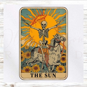 May include: A tarot card illustration featuring a skeleton riding a horse in front of a large yellow sun. The card is framed with a beige border and the words "THE SUN" are at the bottom. Sunflowers are in the foreground.