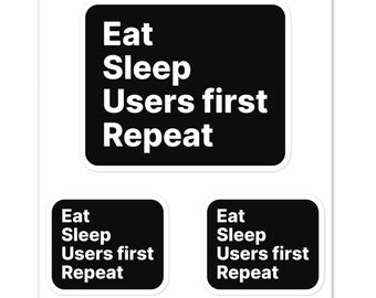 May include: Three black and white stickers with the text "Eat Sleep Users first Repeat" on each.