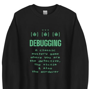 May include: Black sweatshirt featuring the word "DEBUGGING" in green, with a description of a mystery game. The sweatshirt also has three symbols above the word "DEBUGGING".