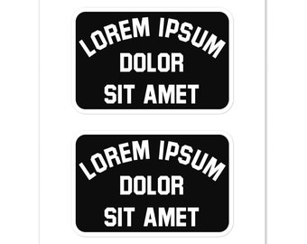 May include: Two black rectangular stickers with rounded corners. Each sticker has white text that reads "LOREM IPSUM DOLOR SIT AMET" in a bold, sans-serif font. The stickers are on a white background.