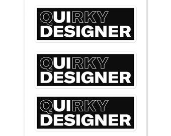 May include: Three black and white stickers with the text "Quirky Designer" in a bold, outlined font.