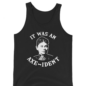 May include: Black tank top with a white graphic of a woman's portrait and the text "IT WAS AN AXE-IDENT". The sleeveless shirt is made of a soft material.